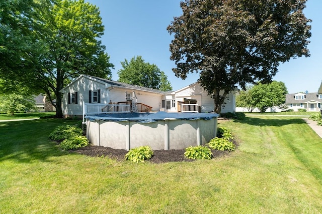 5243 W 53rd St, Fairview, PA 16415 - rear view of property with a lawn, a covered pool, and a deck