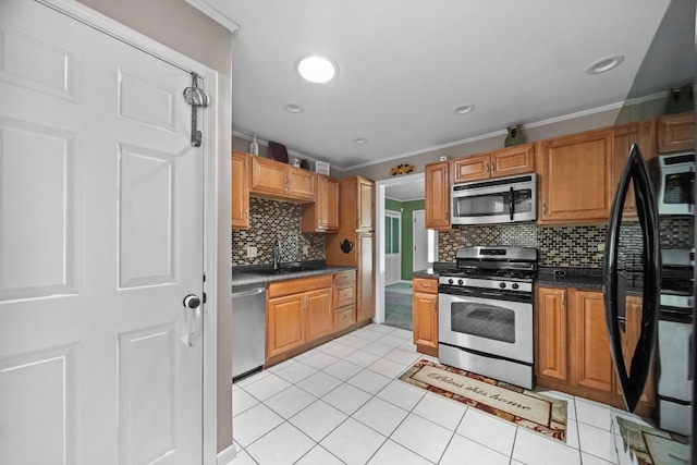 5243 W 53rd St, Fairview, PA 16415 - kitchen with appliances with stainless steel finishes, crown molding, backsplash, dark countertops, and light tile patterned floors