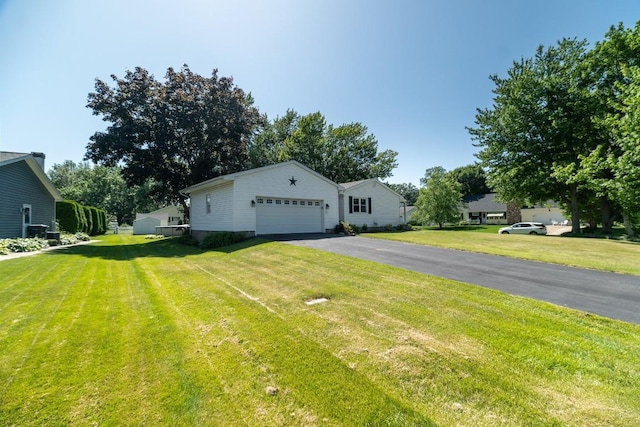 5243 W 53rd St, Fairview, PA 16415 - view of front of house with driveway, an attached garage, and a front lawn