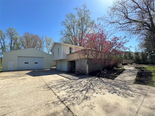 exterior space with a detached garage and an outbuilding