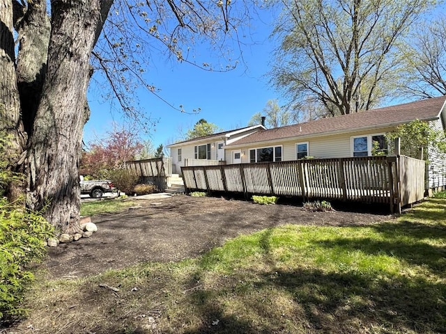 rear view of house featuring a deck