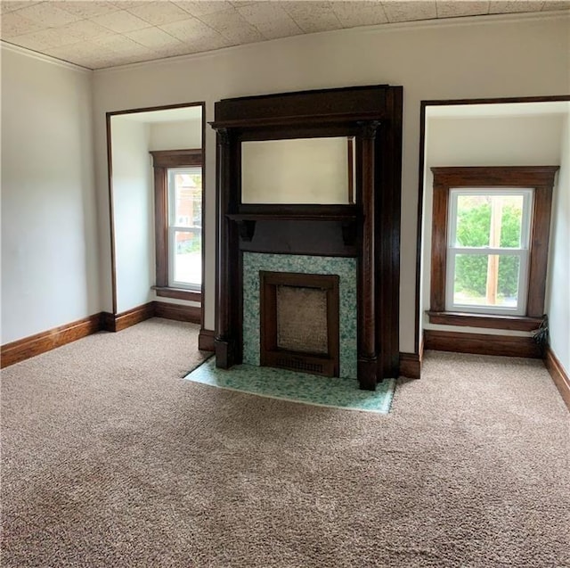 unfurnished living room featuring crown molding and light carpet