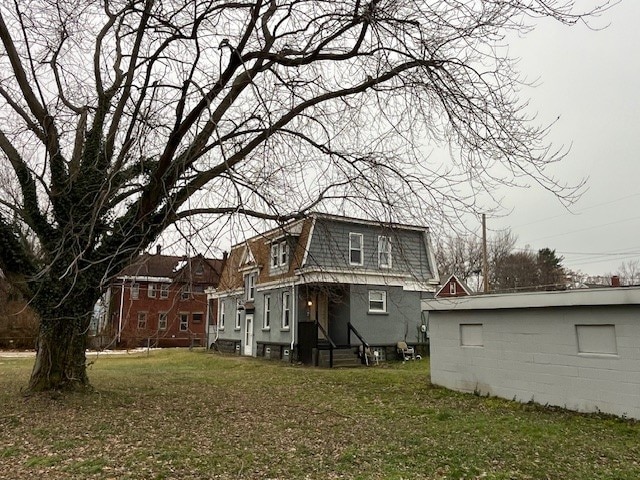 rear view of property featuring a yard