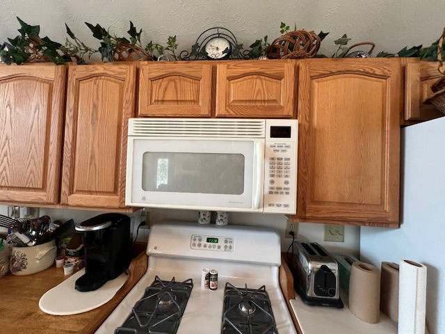 13478 Old Lake Rd Unit 62, East Springfield, PA 16411 - kitchen featuring white microwave and gas stove