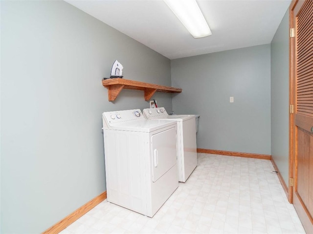 laundry area with light floors, washing machine and clothes dryer, baseboards, and laundry area