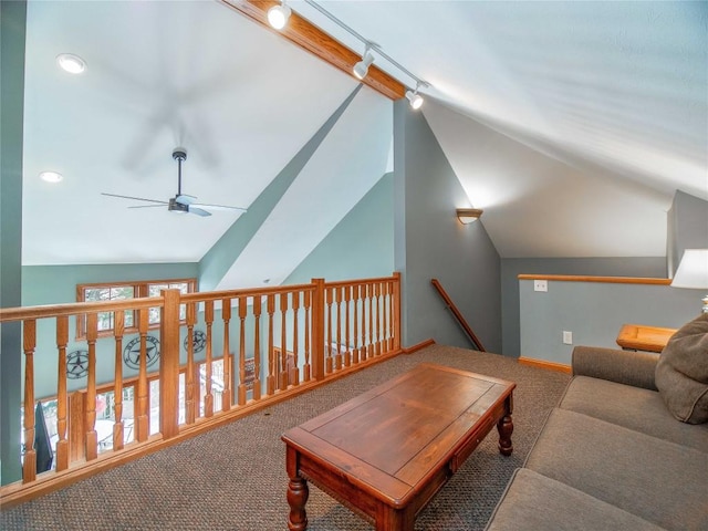 living room featuring lofted ceiling, a ceiling fan, and carpet