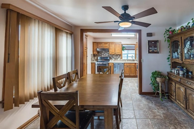 dining room featuring ceiling fan and sink