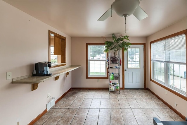 doorway to outside with light tile patterned floors and ceiling fan