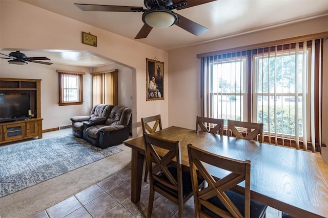 tiled dining area featuring ceiling fan