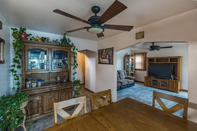 carpeted dining space featuring ceiling fan