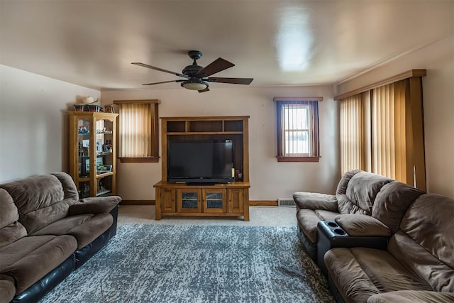 carpeted living room with ceiling fan