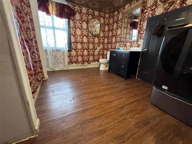 bathroom featuring toilet, hardwood / wood-style flooring, and vanity