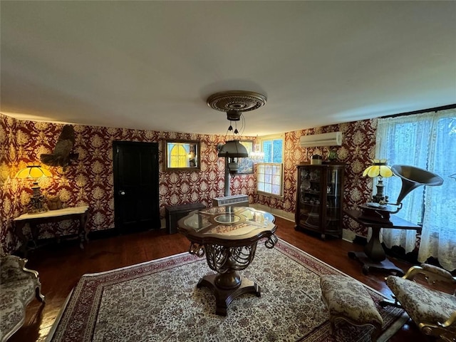 living room with dark hardwood / wood-style flooring and a wall unit AC