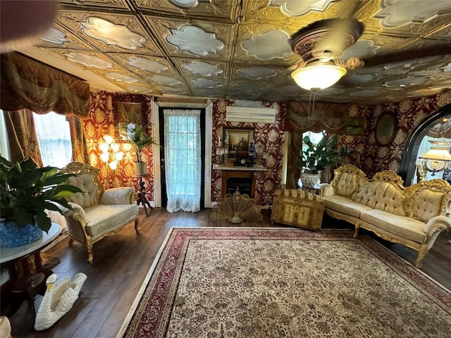 living area with hardwood / wood-style flooring and an AC wall unit