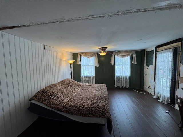 unfurnished bedroom featuring ceiling fan and dark hardwood / wood-style floors