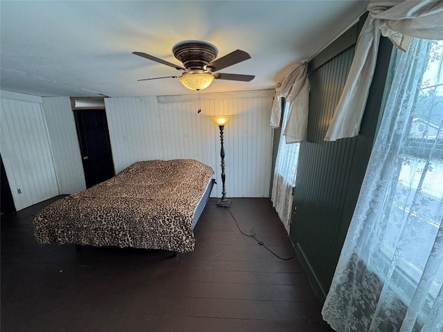 bedroom with ceiling fan and dark hardwood / wood-style floors