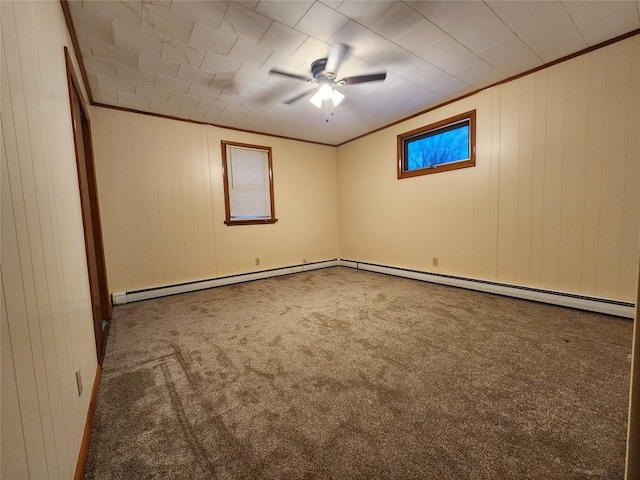 carpeted spare room with wood walls and crown molding