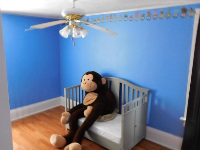 unfurnished bedroom with ceiling fan and wood-type flooring