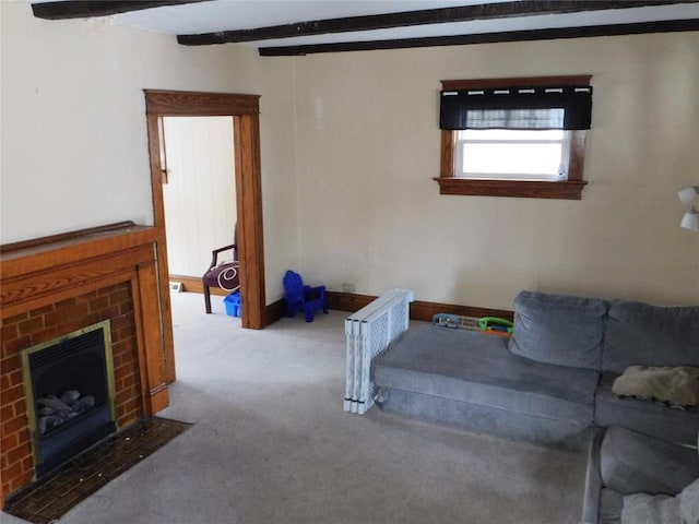 living room featuring beamed ceiling, light colored carpet, and a fireplace