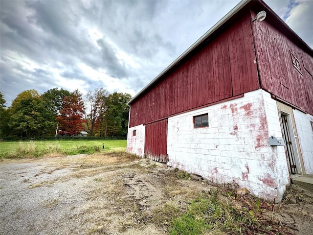 view of property exterior featuring an outbuilding