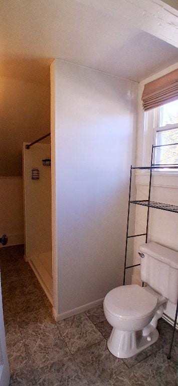2677 Cherry St, Erie, PA 16508 - bathroom featuring baseboards, a walk in shower, and toilet