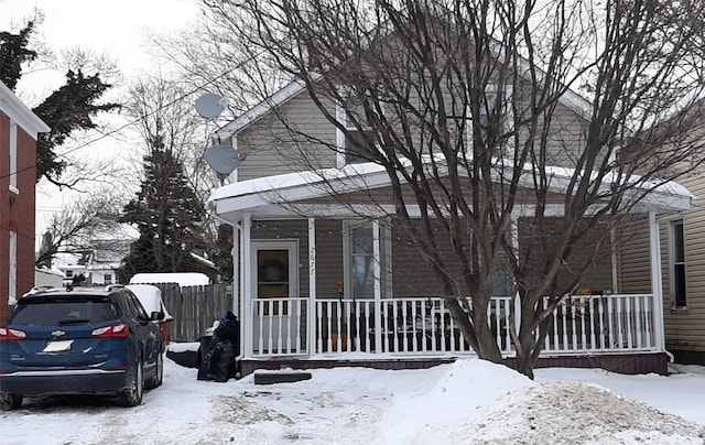 snow covered property featuring a porch