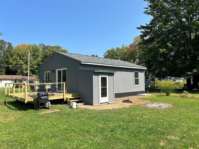 back of house featuring a yard and a deck