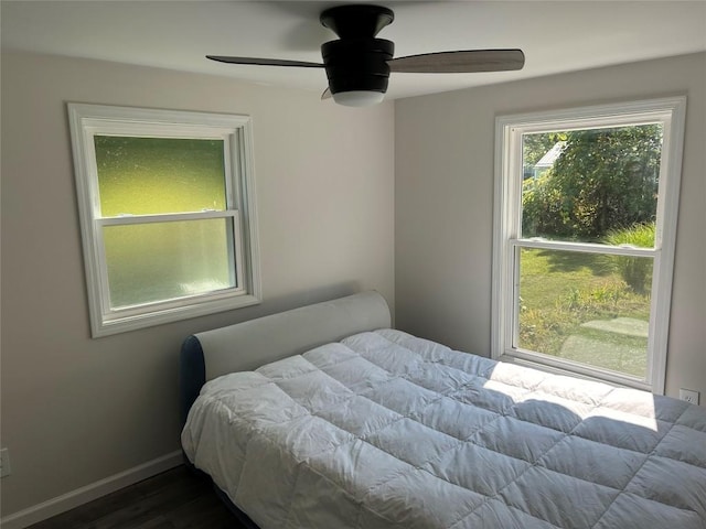 bedroom featuring ceiling fan and dark hardwood / wood-style floors