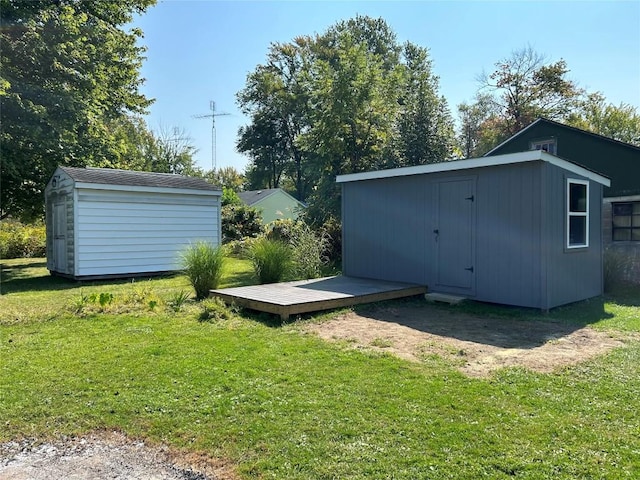 view of storm shelter featuring a storage unit and a yard