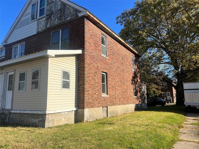 view of property exterior featuring a lawn