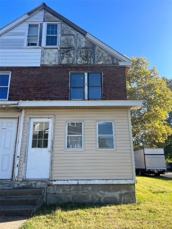 view of side of property with a yard