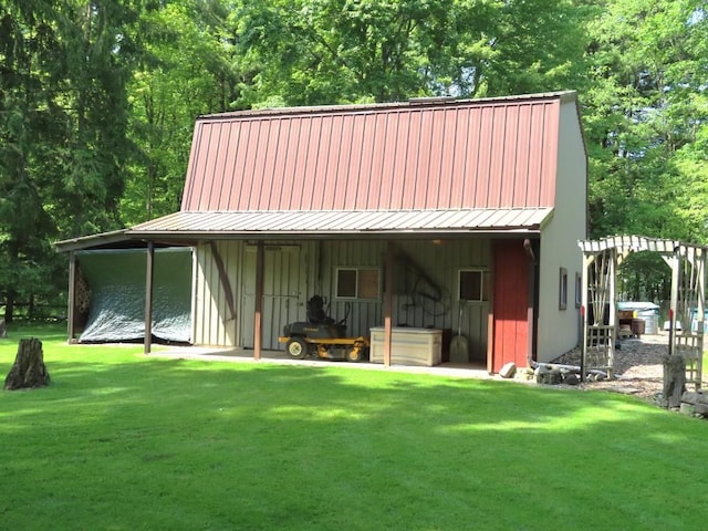 1900 Navaho Rd, Jamestown, PA 16134 - rear view of house featuring a lawn, board and batten siding, an outbuilding, and a metal roof