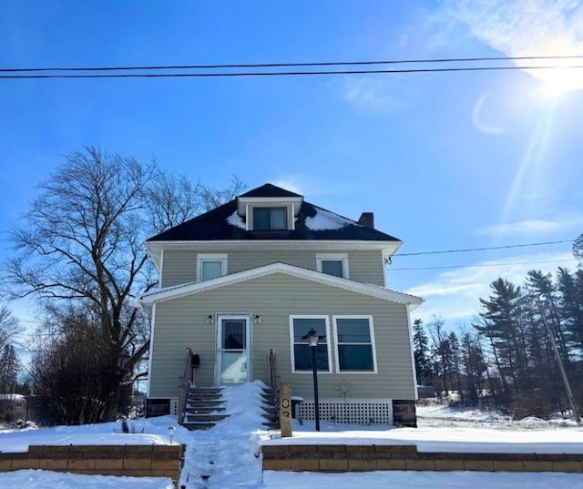 american foursquare style home featuring a chimney