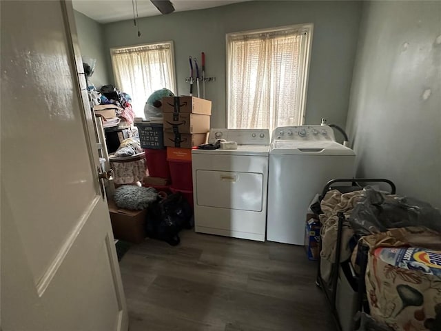 laundry area with laundry area, washer and clothes dryer, a ceiling fan, and wood finished floors