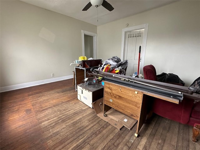 interior space featuring dark wood-type flooring, a ceiling fan, and baseboards