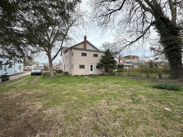 exterior space featuring a lawn and a chimney