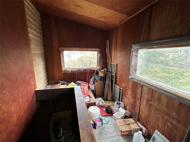 miscellaneous room featuring wood walls, vaulted ceiling, and hardwood / wood-style flooring