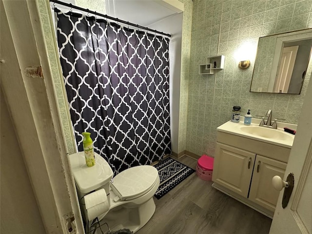 bathroom featuring vanity, a shower with curtain, toilet, and wood finished floors