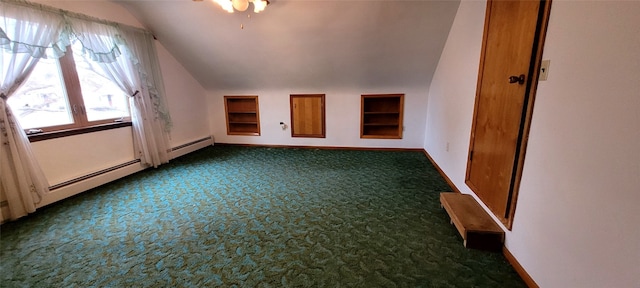 additional living space featuring ceiling fan, dark carpet, and lofted ceiling