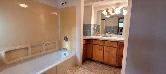 bathroom featuring a bathtub, vanity, and a chandelier