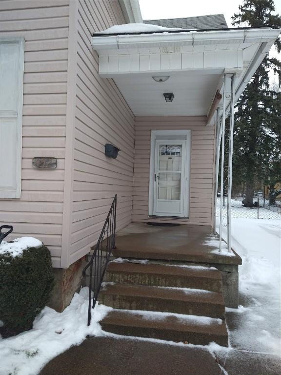 view of snow covered property entrance