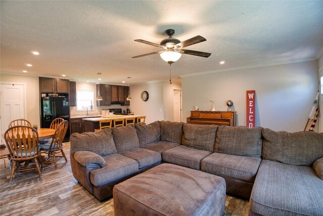 134 Primrose Ln, Edinboro, PA 16412 - living room featuring wood finished floors, ceiling fan, ornamental molding, recessed lighting, and a textured ceiling
