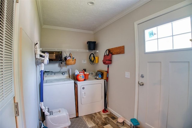 134 Primrose Ln, Edinboro, PA 16412 - laundry room with washing machine and dryer, wood finished floors, a textured ceiling, and crown molding