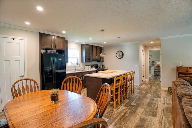 134 Primrose Ln, Edinboro, PA 16412 - dining room with recessed lighting, wood finished floors, a textured ceiling, and ornamental molding