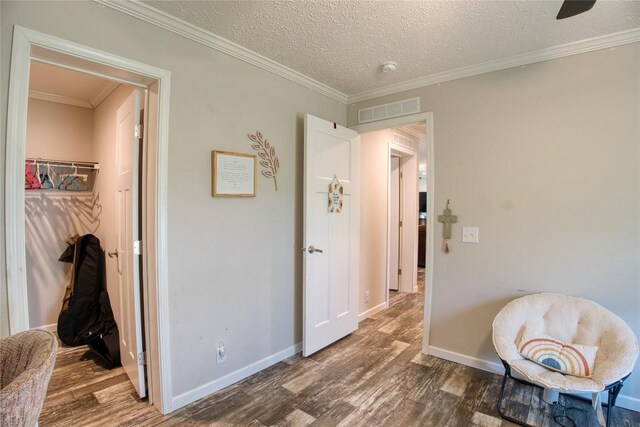 134 Primrose Ln, Edinboro, PA 16412 - hallway featuring wood finished floors, a textured ceiling, and crown molding