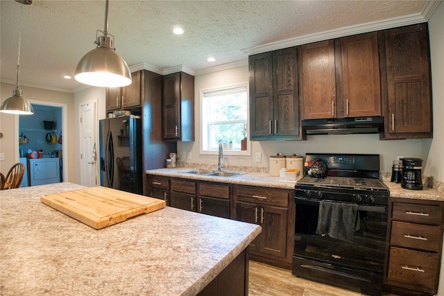 134 Primrose Ln, Edinboro, PA 16412 - kitchen featuring black appliances, under cabinet range hood, washing machine and clothes dryer, light countertops, and dark brown cabinetry