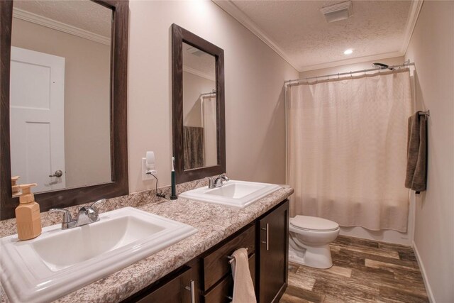 134 Primrose Ln, Edinboro, PA 16412 - full bath with a textured ceiling, wood finished floors, crown molding, double vanity, and shower / bath combo