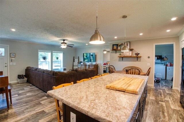 134 Primrose Ln, Edinboro, PA 16412 - kitchen featuring dark wood-style floors, ornamental molding, a textured ceiling, recessed lighting, and decorative light fixtures