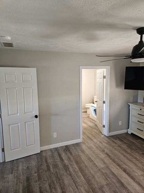 1925 N Mill St, North East, PA 16428 - unfurnished bedroom featuring a textured ceiling, visible vents, wood finished floors, baseboards, and ensuite bath