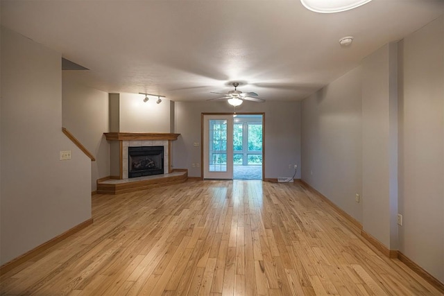 4119 Wood Hills Dr Unit C23, Erie, PA 16510 - unfurnished living room with a ceiling fan, light wood-style flooring, a tiled fireplace, and baseboards